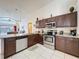 Kitchen area featuring stainless steel appliances, granite countertops, and dark cabinets at 4707 Pershoie Ln, Kissimmee, FL 34746