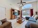Cozy living room with vaulted ceilings, comfortable seating, and a view of the outdoor pool area at 4707 Pershoie Ln, Kissimmee, FL 34746