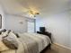 Spacious main bedroom featuring a ceiling fan, a tv on a dresser, and a window with mini blinds at 4707 Pershoie Ln, Kissimmee, FL 34746