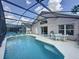 Backyard pool area with lounge seating, dining set, and screen enclosure at 4707 Pershoie Ln, Kissimmee, FL 34746