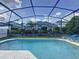 Refreshing screened-in pool, perfect for relaxation and outdoor enjoyment with manicured landscaping at 4707 Pershoie Ln, Kissimmee, FL 34746