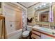 Bathroom with a shower and tub combo, a toilet, a vanity with a sink and a mirror at 4824 Reginald Rd, Orlando, FL 32829