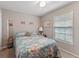 Bedroom with a bed, carpeted floors, light colored walls, a window, and a mirror at 4824 Reginald Rd, Orlando, FL 32829