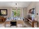 Charming dining area with natural light, neutral colors, and wood-look floors for elegant entertaining at 4824 Reginald Rd, Orlando, FL 32829
