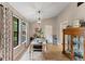 Dining room features hardwood floor, vaulted ceiling, chandelier, and a beautifully set table at 4824 Reginald Rd, Orlando, FL 32829