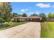 Charming single-story home featuring a well-maintained lawn and a spacious driveway leading to the garage at 4824 Reginald Rd, Orlando, FL 32829