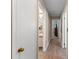Hallway with doors, neutral paint, baseboards, and wood-look flooring at 4824 Reginald Rd, Orlando, FL 32829