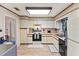 Bright kitchen with clean white cabinets, modern appliances, and wood-look flooring at 4824 Reginald Rd, Orlando, FL 32829