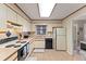 A well-lit kitchen with white cabinets, appliances, and flooring creating a clean and inviting space at 4824 Reginald Rd, Orlando, FL 32829