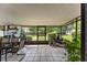 Sunroom with tile flooring, a dining table, chairs, plants, and sliding doors to the backyard at 4824 Reginald Rd, Orlando, FL 32829