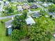 An aerial view of the residential neighborhood featuring houses, green foliage, and a pool at 512 Maryland Ave, St Cloud, FL 34769