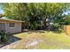 Spacious, partially shaded backyard with lush greenery and wooden fence offers privacy at 512 Maryland Ave, St Cloud, FL 34769