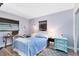 A cozy bedroom with a blue bedspread and coordinating turquoise dresser at 512 Maryland Ave, St Cloud, FL 34769