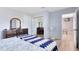 Comfortable bedroom shows wood floors, a dresser, and a doorway leading to another room with TV at 512 Maryland Ave, St Cloud, FL 34769