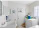 Bright laundry room with white walls, a utility sink, and a modern washing machine and dryer at 512 Maryland Ave, St Cloud, FL 34769