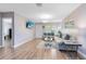 Open-concept living room with hardwood floors, a wall-mounted TV, and seamless flow to other areas at 512 Maryland Ave, St Cloud, FL 34769