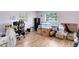 Image of a room, currently used for storage, featuring hardwood floors and multiple windows at 512 Maryland Ave, St Cloud, FL 34769