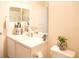 Bright bathroom featuring a vanity with a sink, a mirror, and decor on the counter next to the toilet at 5506 Glen Lake Ln, Orlando, FL 32808