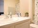 Bright bathroom featuring a vanity with a sink, a mirror, and a shower-tub combo with a floral curtain at 5506 Glen Lake Ln, Orlando, FL 32808
