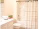 Bright bathroom featuring a shower-tub combo with a patterned curtain and a white vanity with decorative accents at 5506 Glen Lake Ln, Orlando, FL 32808