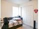 This bedroom boasts sleek wood floors, natural light from the window, and a closet with sliding doors at 5506 Glen Lake Ln, Orlando, FL 32808