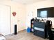 This bedroom features sleek gray wood floors, a large TV, and ample storage with drawers and shelving at 5506 Glen Lake Ln, Orlando, FL 32808