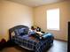 Bedroom with a large window, plush bedding, and ample natural light, creating a comfortable and inviting space at 5506 Glen Lake Ln, Orlando, FL 32808