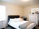 Bright bedroom featuring a large window, gray upholstered headboard, white bedding, and a large white dresser at 5506 Glen Lake Ln, Orlando, FL 32808