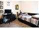 Bedroom with bed, desk, skateboard, and various decorations in a modern styled room at 5506 Glen Lake Ln, Orlando, FL 32808