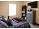 Bedroom features a dresser, soft bedding, and ample natural light, creating a restful atmosphere at 5506 Glen Lake Ln, Orlando, FL 32808