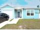 Lovely light blue single-story home with a one-car garage and a concrete driveway on a sunny day at 5506 Glen Lake Ln, Orlando, FL 32808
