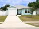 Inviting single-story home featuring a one-car garage, light blue siding, and a welcoming front porch at 5506 Glen Lake Ln, Orlando, FL 32808
