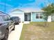 Inviting single-story home with a one-car garage, light blue siding, and a long concrete driveway at 5506 Glen Lake Ln, Orlando, FL 32808