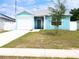 Charming single-story home featuring a one-car garage, light blue siding, and a cozy front porch at 5506 Glen Lake Ln, Orlando, FL 32808