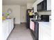 Open-concept kitchen with modern appliances, white cabinets, and a seamless flow into the dining area at 5506 Glen Lake Ln, Orlando, FL 32808