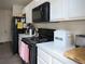 Close up view of the kitchen with black appliances and white countertops, perfect for cooking enthusiasts at 5506 Glen Lake Ln, Orlando, FL 32808