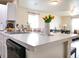 Bright kitchen island, white countertops, and a clear view into the open concept dining and living areas at 5506 Glen Lake Ln, Orlando, FL 32808