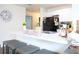 Kitchen island with seating overlooking dining and living areas and black appliances with white cabinets at 5506 Glen Lake Ln, Orlando, FL 32808