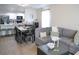Open-concept living room and kitchen features modern decor, neutral tones, and ample natural light at 5506 Glen Lake Ln, Orlando, FL 32808