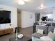 Comfortable living room and dining area features neutral tones, modern decor, and lots of natural light at 5506 Glen Lake Ln, Orlando, FL 32808