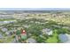 An aerial view of a residential community featuring lush landscaping, pool, tennis courts and a lake at 607 Gran Bahama Blvd # B29/U607, Davenport, FL 33897