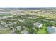 An aerial view of a residential community featuring lush landscaping, pool, tennis courts and a lake at 607 Gran Bahama Blvd # B29/U607, Davenport, FL 33897