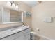 Bathroom with a granite topped vanity, a framed mirror, and a glass-enclosed shower, and neutral-toned walls at 607 Gran Bahama Blvd # B29/U607, Davenport, FL 33897