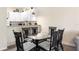 Cozy dining area features a glass-top table with six chairs, white walls, and a view of the kitchen at 607 Gran Bahama Blvd # B29/U607, Davenport, FL 33897
