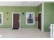 Condo entrance featuring a brown door, a window with blinds, and green siding at 607 Gran Bahama Blvd # B29/U607, Davenport, FL 33897