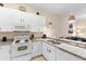 Bright kitchen boasts white cabinets, granite countertops, and stainless steel sink with bar seating at 607 Gran Bahama Blvd # B29/U607, Davenport, FL 33897