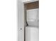 Laundry closet featuring a stacked washer and dryer unit behind a white door at 607 Gran Bahama Blvd # B29/U607, Davenport, FL 33897