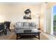 Bright living room features a comfortable sofa, stylish coffee table, and sliding glass doors to the balcony at 607 Gran Bahama Blvd # B29/U607, Davenport, FL 33897