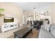 Open-concept living room with a sofa, stylish coffee table, and seamless connection to the dining area and kitchen at 607 Gran Bahama Blvd # B29/U607, Davenport, FL 33897