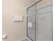 Glass enclosed shower with white tile and built-in shelving with provided toiletries, and towel rack at 607 Gran Bahama Blvd # B29/U607, Davenport, FL 33897